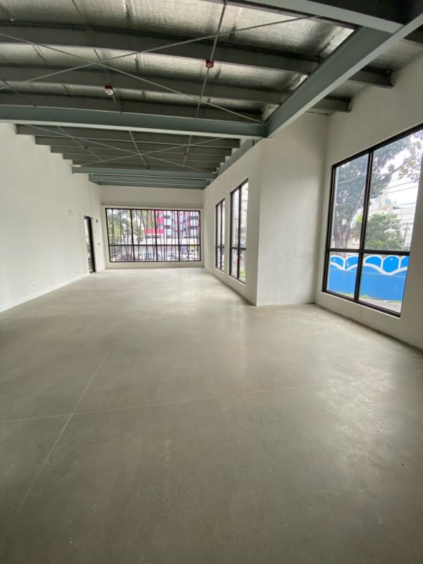 Bright commercial interior with concrete floor and exposed ceilings Plaza Río Abajo Panama