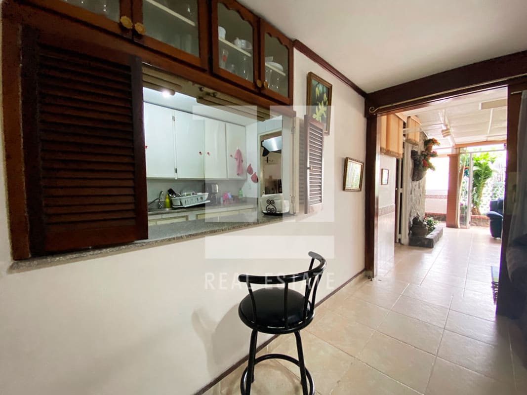 Patio enclosed terrace with plants, stone wall accents, blue sofa in Panama City home