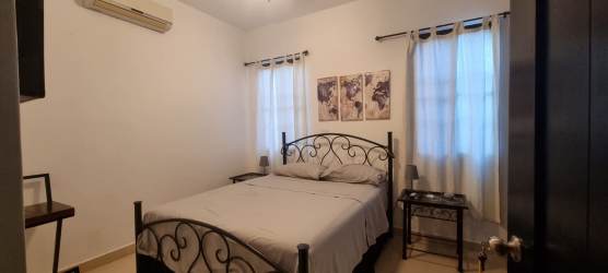 Kitchen with granite countertops, wood cabinets and kitchen island with wine rack in Hacienda Pacifica San Carlos Panama