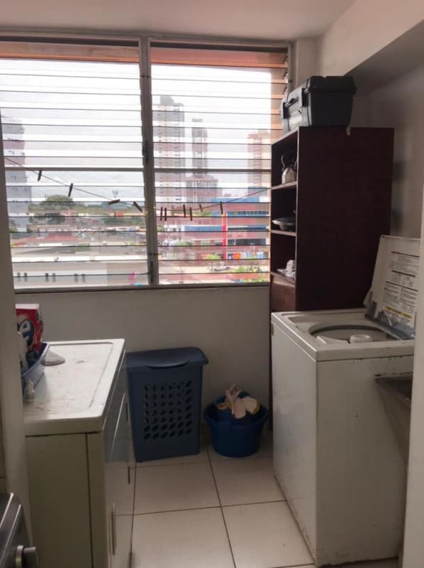 Bedroom with neutral decor, large window, ceiling fan PH Sunset Place San Francisco Panama