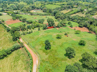 Scenic countryside farmland view in Santa Rita with dirt roads and green hills