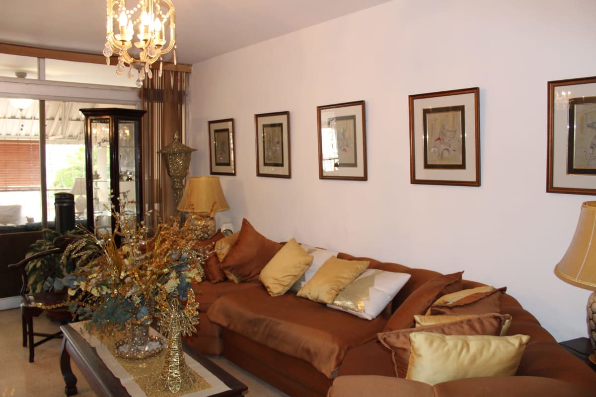 Bright living and dining room area with large windows, traditional furniture in duplex house Hato Pintado Panama