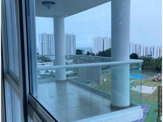 Modern open living area with island kitchen, dining table, sofa and access to sea view balcony in PH Waterways Playa Blanca