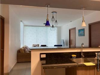 Fully equipped kitchen with granite countertops open to living room in PH Waterways Playa Blanca Panama