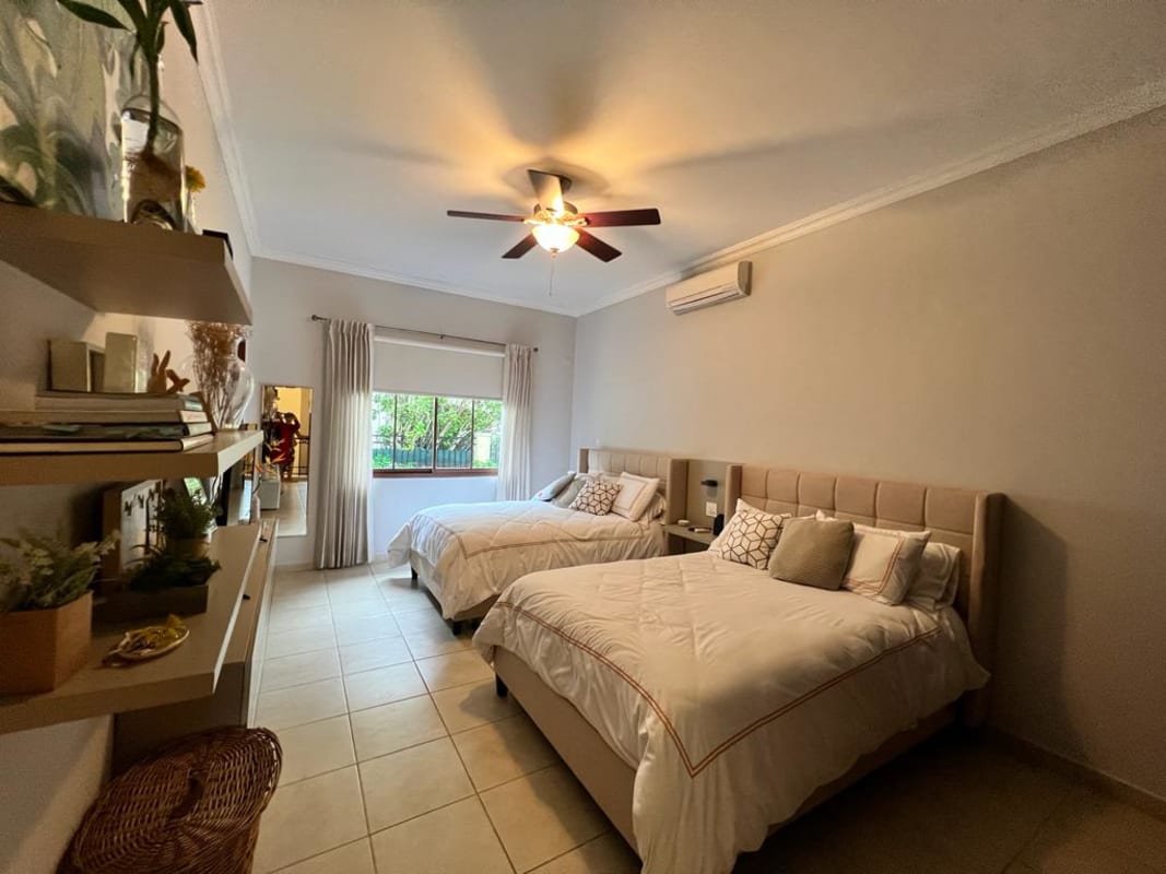 Grand living room with double height ceiling, modern chandelier, large windows camino de cruces panama
