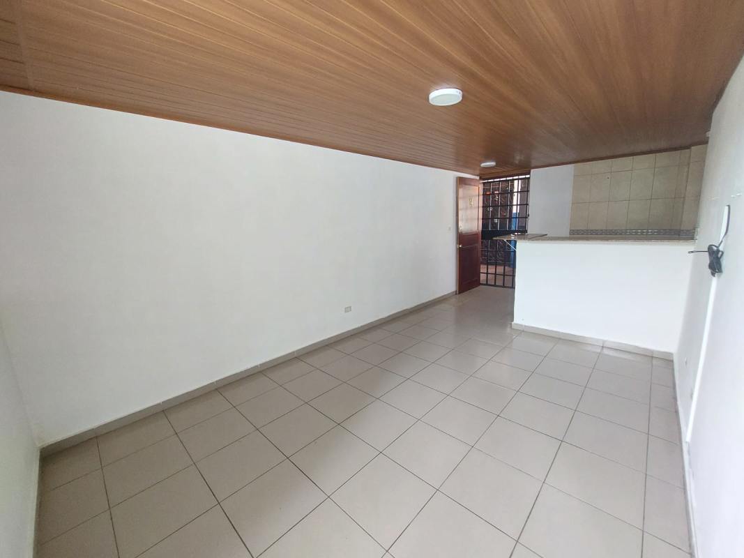 Bedroom with built-in wardrobe, wood ceiling, tiled floor at Villa Lorena Panama City