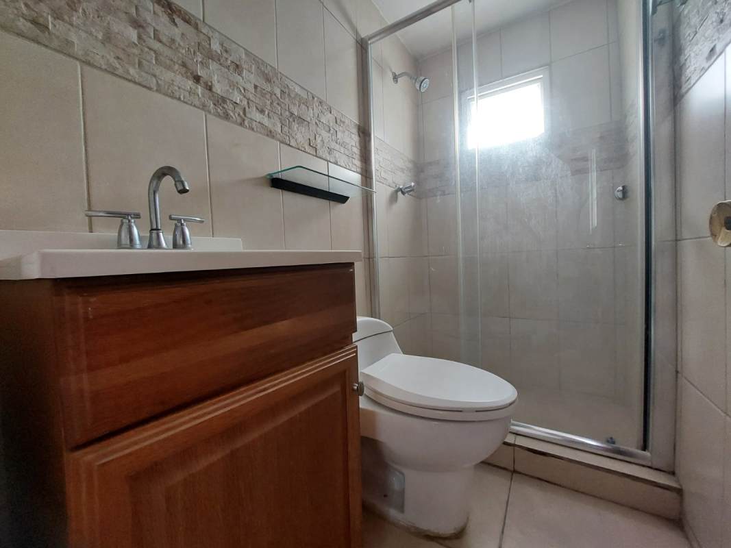 Bedroom with built-in closet, tile floors, window natural light Villa Lorena Apartment Panama City