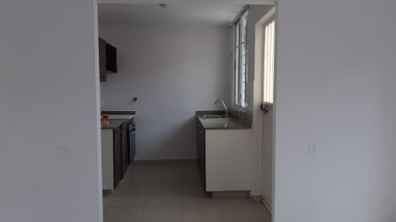 Compact kitchen with window and minimalist cabinetry in Villas de Aragón Arraiján
