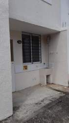 Kitchen with large window and minimalist cabinetry in Villas de Aragón house Panama