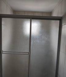 Bedroom interior with built-in dark wardrobe, TV mount, and sunlight in Colinas del Oeste Arraiján home