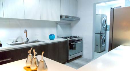 Modern living room with large windows overlooking golf greenery in Tucan Country Club apartment Panama Pacifico