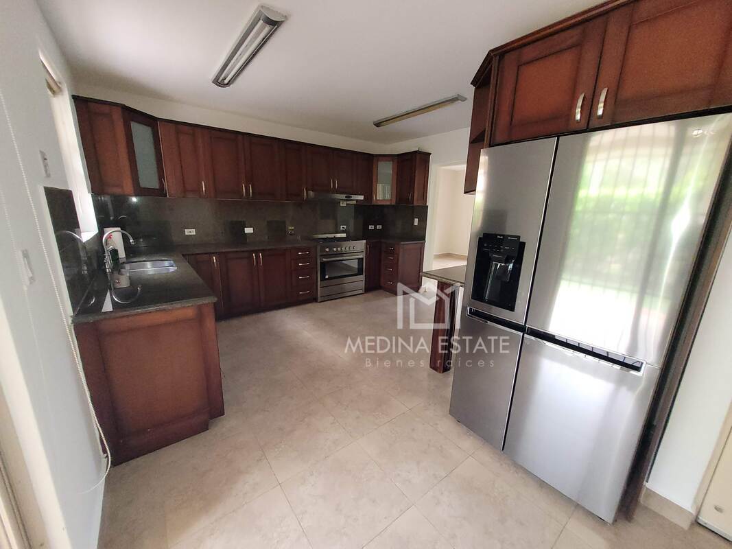 Kitchen with granite countertops, wood cabinets, refrigerator, oven Embassy Gardens Clayton