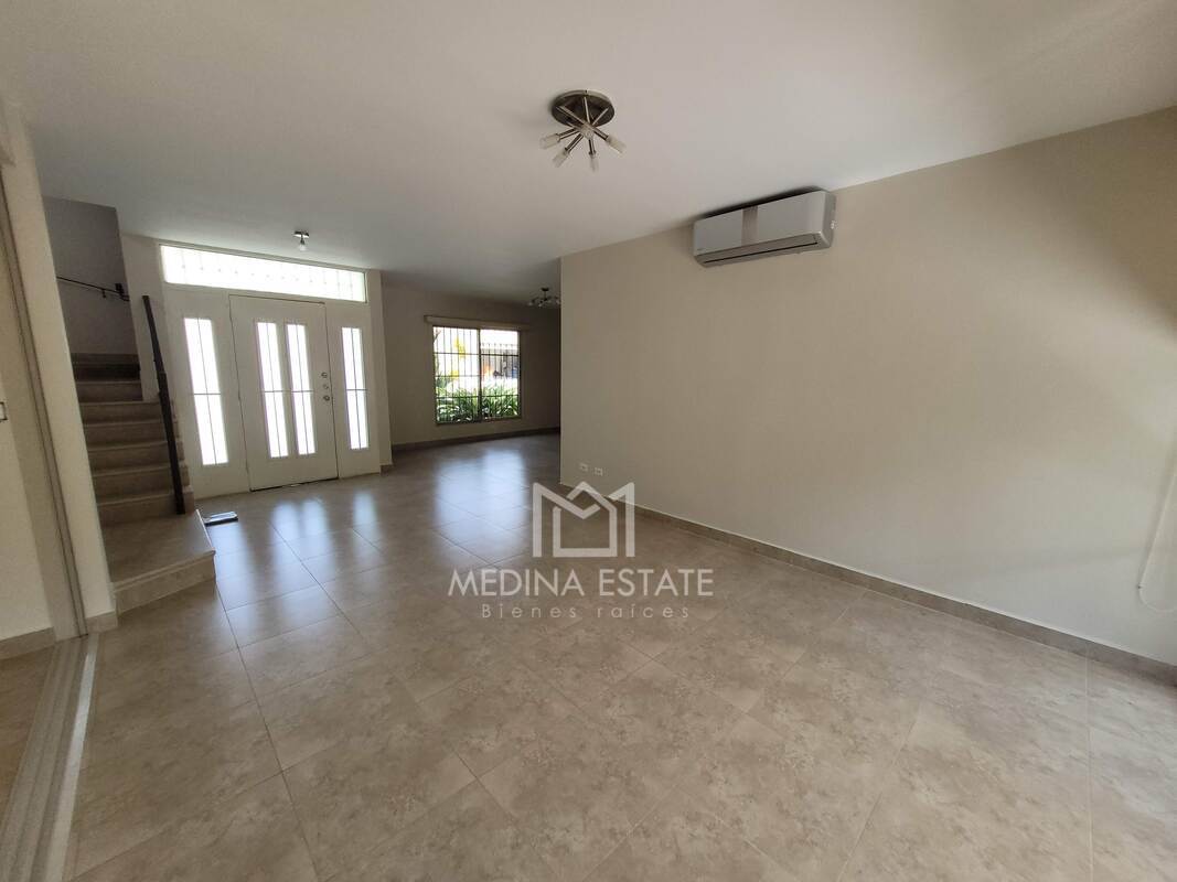 Large living room with tiled flooring, natural light and staircase Embassy Gardens Clayton