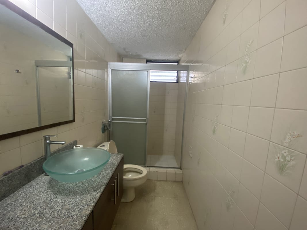 Traditional bathroom with glass vessel sink, granite countertop, glass-enclosed shower in PH Monaco Obarrio