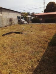 Flat corner lot in Pedasi Los Santos Panama, empty land with fencing and carport visible