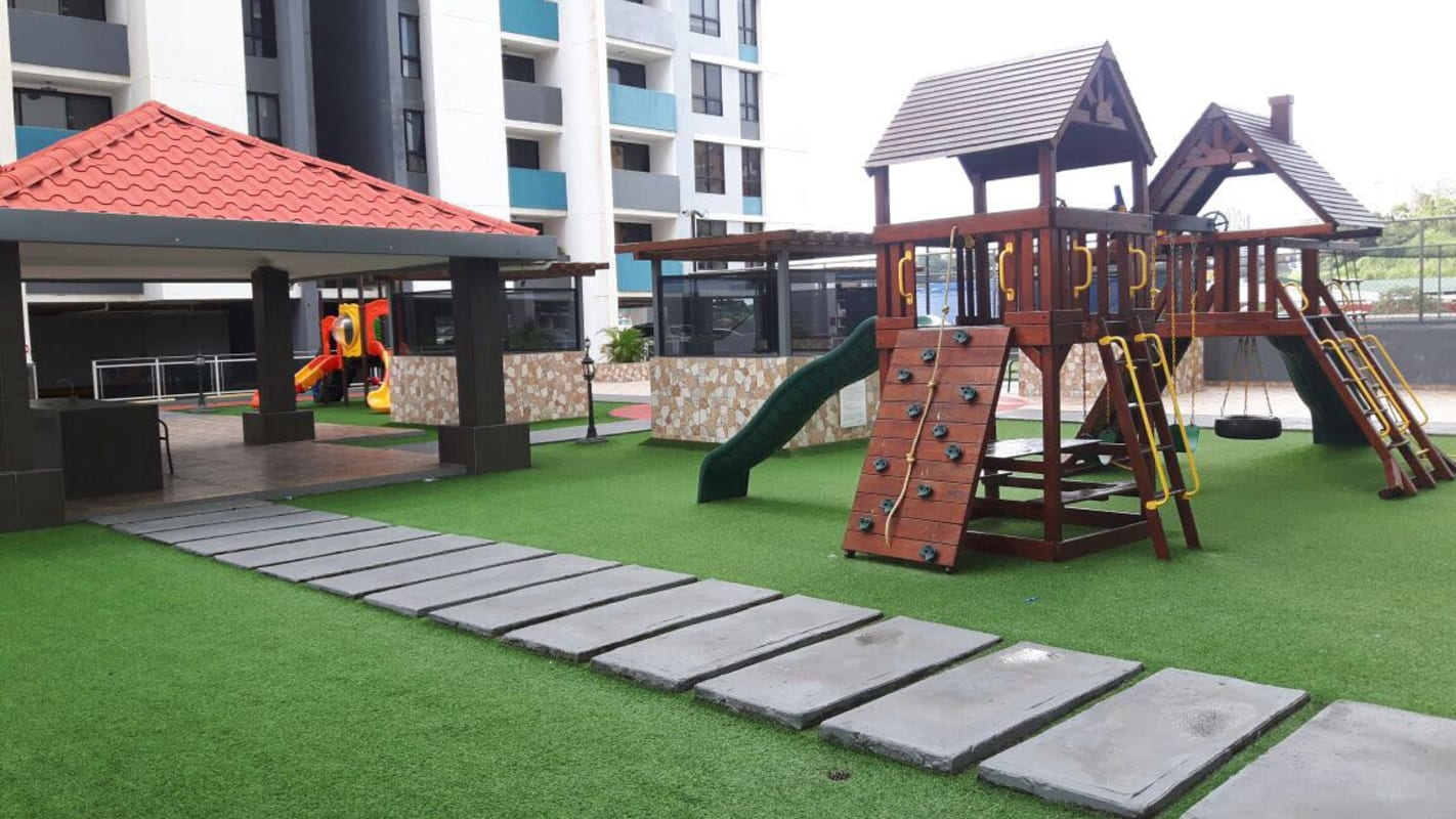 Kids play structures on artificial turf in green zone at PH Terrazas del Rey Condado del Rey Panama