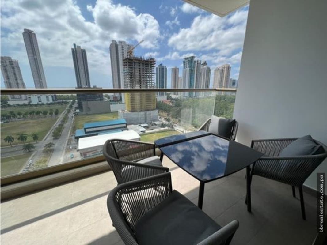 Open kitchen with black granite, grey cabinets, dining nook and city view in PH Parkview apartment