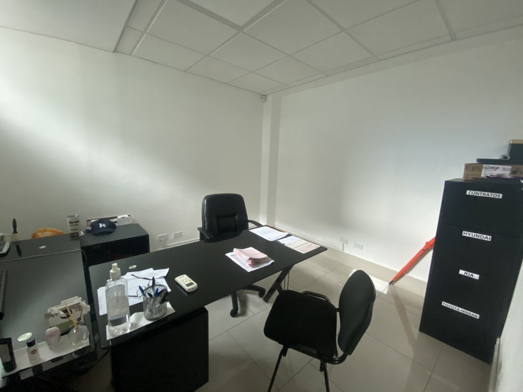 Open workspace office cubicles glass walls tiled floor Panama City El Cangrejo Business Complex