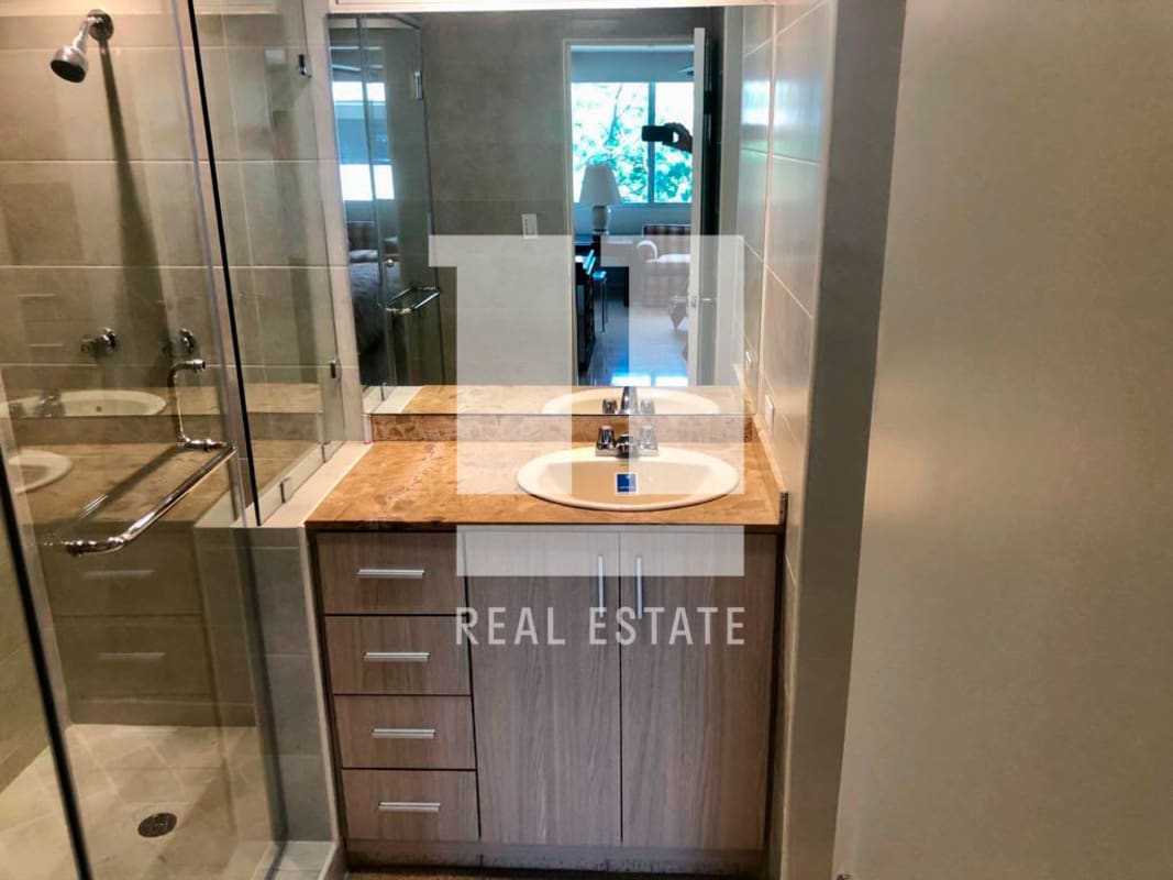 Modern bathroom with marble countertop glass shower PH Parque Marbella Panama