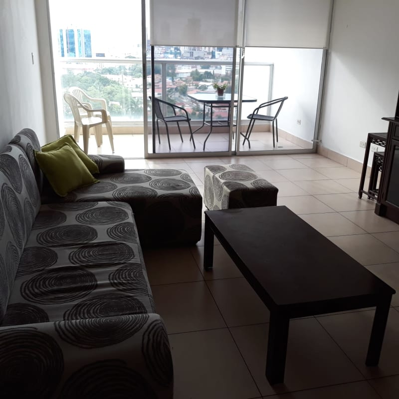 Living room with large windows, city skyline view, and balcony at PH San Francisco 67 in Panama