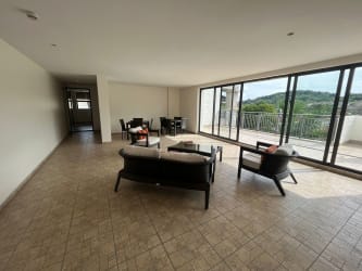 Living dining area with sliding glass doors to terrace PH River Valley Panama Pacifico