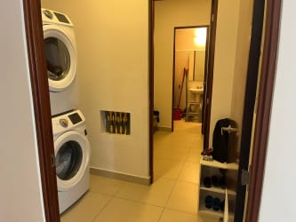 Laundry area with stacked washer dryer PH River Valley Panama Pacifico