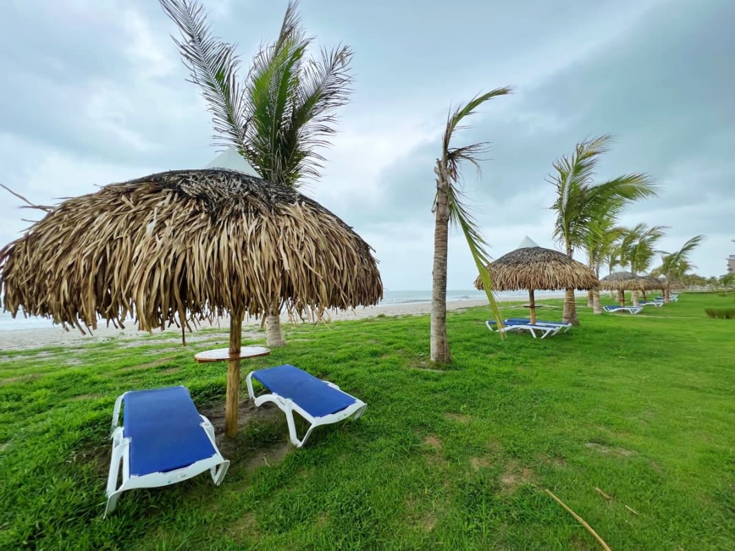 Bright living room with glass doors, gray sectional sofa, coastal decor at Playa Caracol Punta Chame