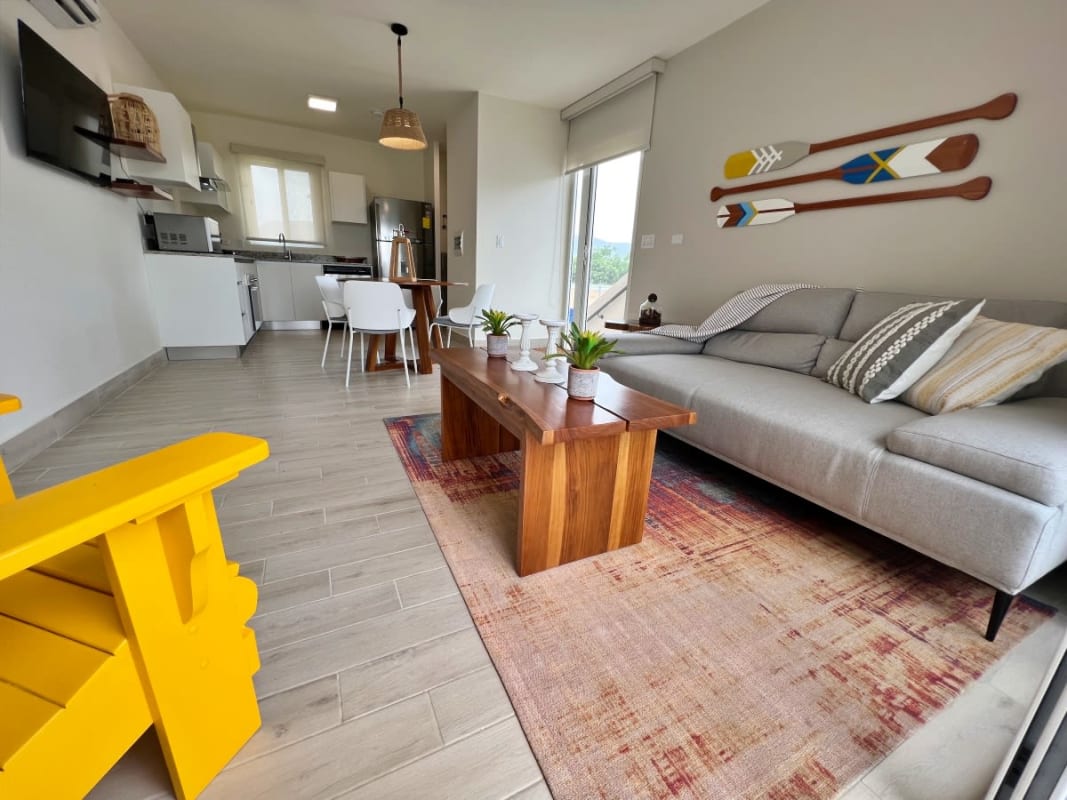 Covered balcony with dining set and ocean views in Playa Caracol beachfront villa