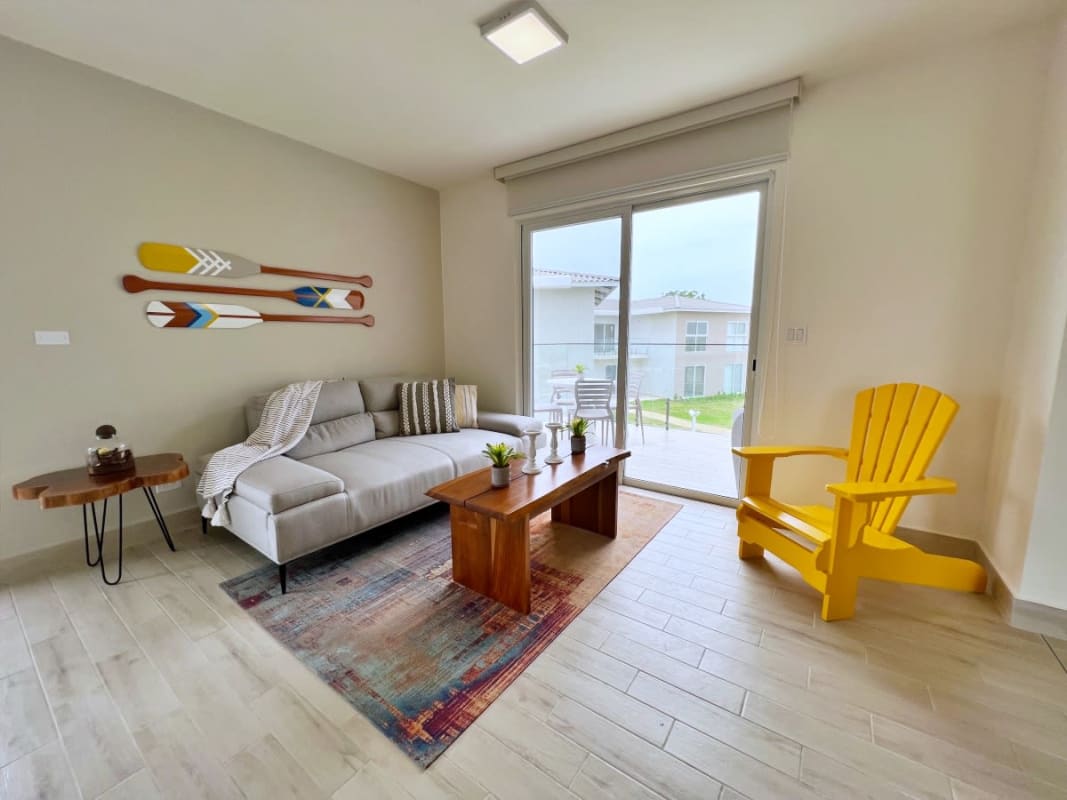 Contemporary kitchen with white cabinetry, granite counters, stainless appliances in Playa Caracol villa
