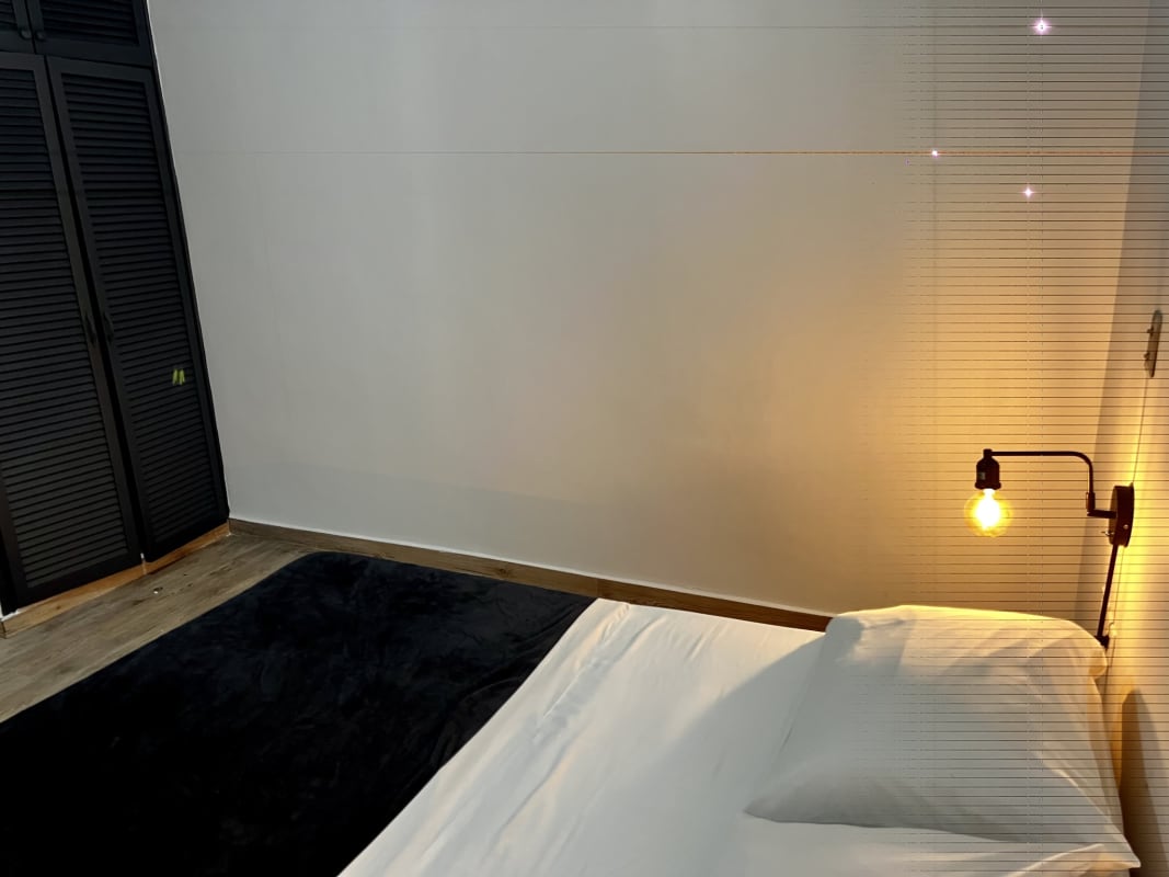 Simple minimalist bedroom with closet and wall lighting in PH Perejil