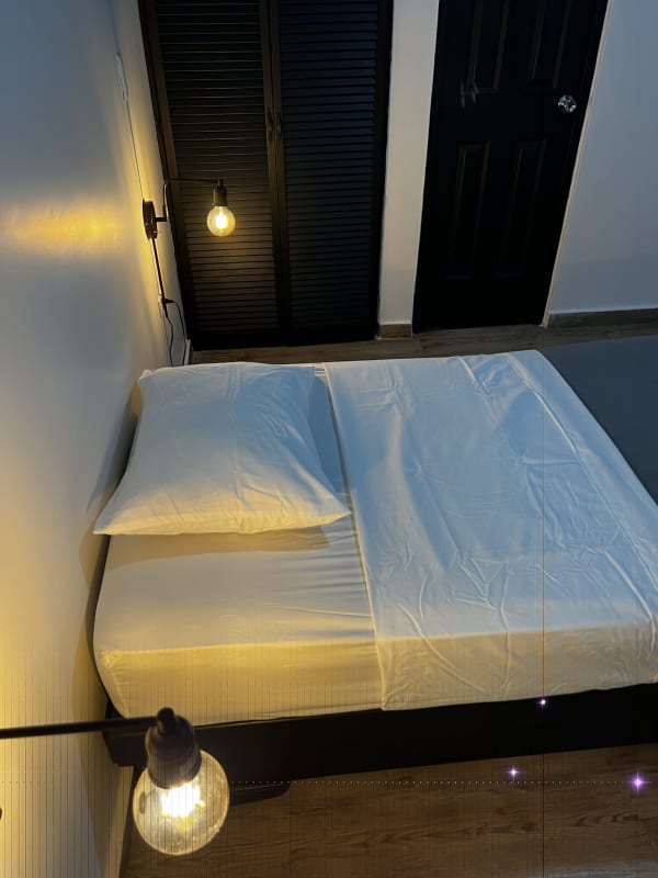 Simple furnished room with AC, black closet door at PH Perejil Panama City