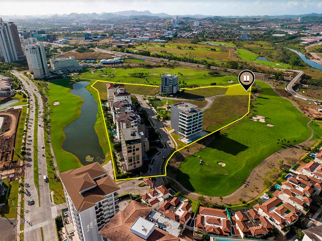 Aerial photo of Santa María Golf & Country Club showing golf course, lake, luxury condos, and property boundary