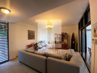 Spacious living area with large windows and garden patio PH Nativa