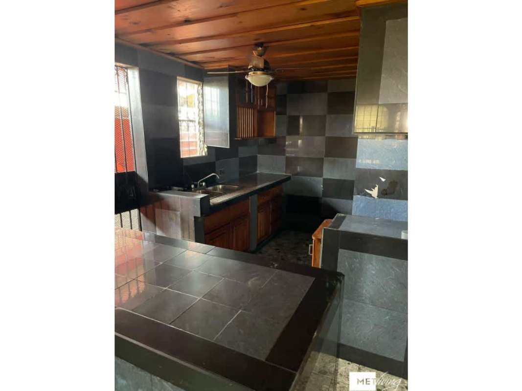 Large bathroom with double vessel sinks, granite countertops, wood cabinetry Cerro Viento home sale Panama