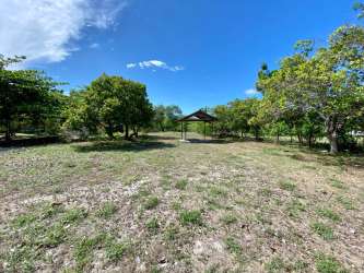 Open outdoor grassy area with gazebo on beachfront lot in Playa Malibú Panama
