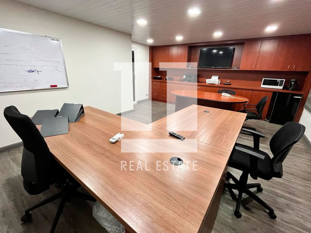 Modern conference room with cherry wood cabinets, black chairs, kitchenette area Coco del Mar Panama