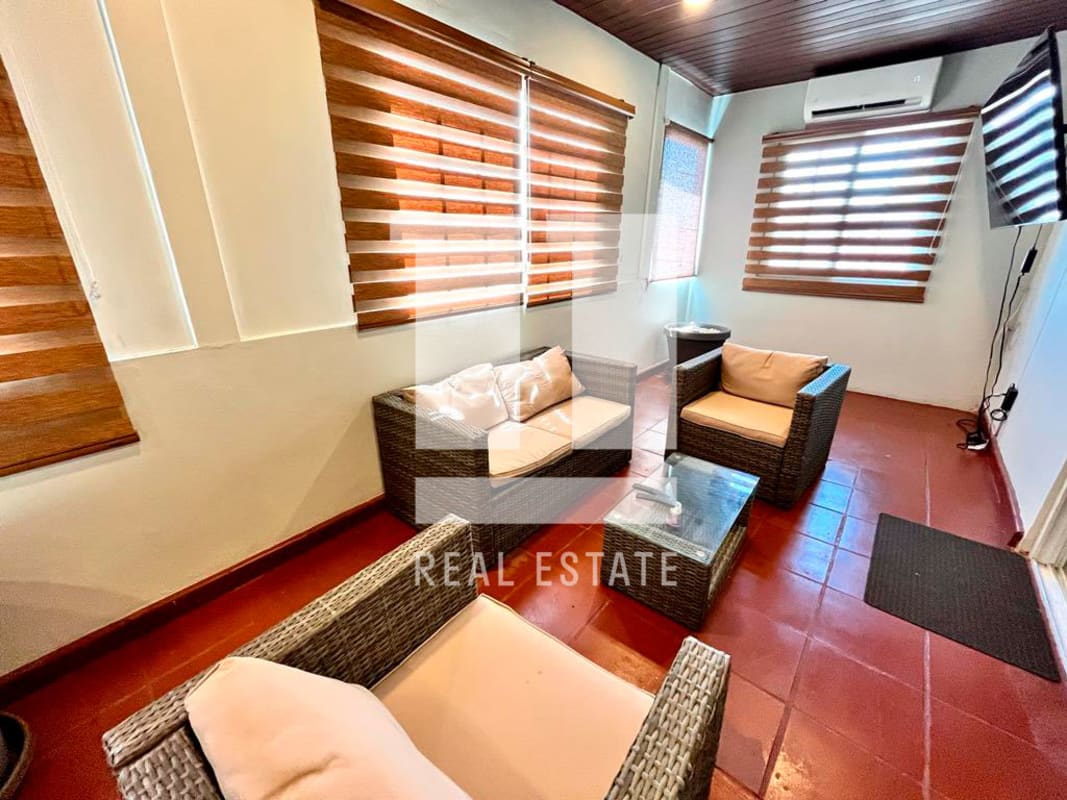 Reception/living area with wicker seating, blinds, tiled floor Coco del Mar