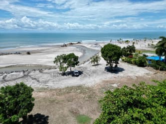 Open-concept living room with large sliding doors to terrace ocean view Playa Blanca Panama