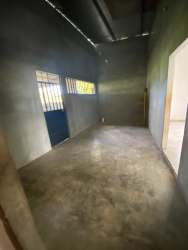 Living area with wooden floor, blue wall and window Penonomé rural home