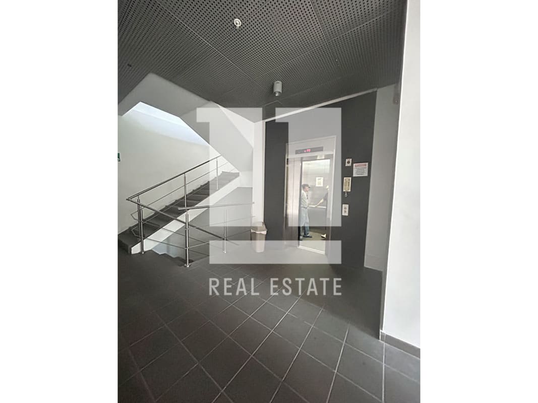 Modern commercial elevator lobby with tiled floors elevator and stairs Peatonal 68 Panama City