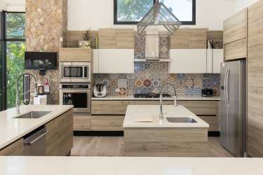Italian designer kitchen with island, stainless appliances in Punta Barco beachfront villa Panama