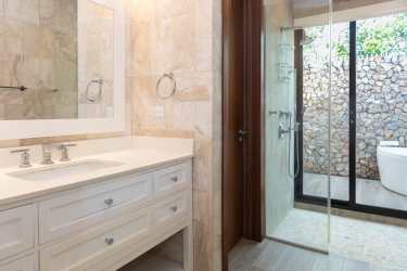 Private pool area with pergola surrounded by tropical garden Punta Barco beachfront home