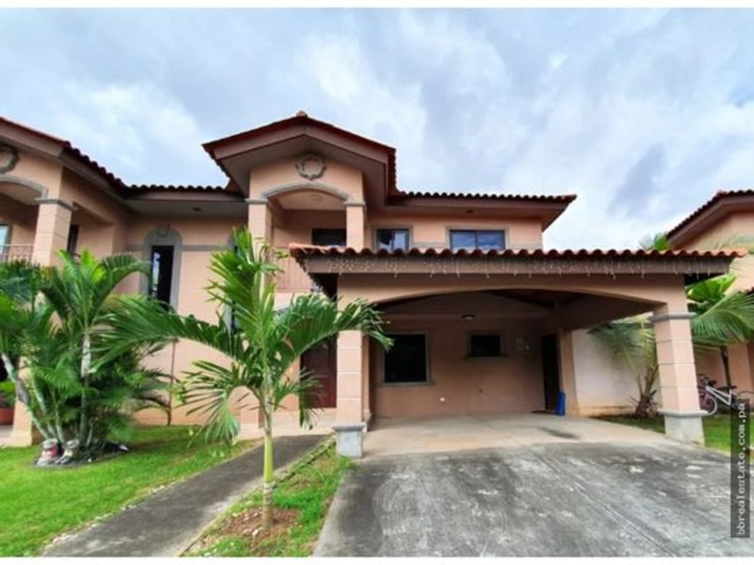 Two-story Mediterranean style house with tile roof and arches in Versalles Costa Sur Panama