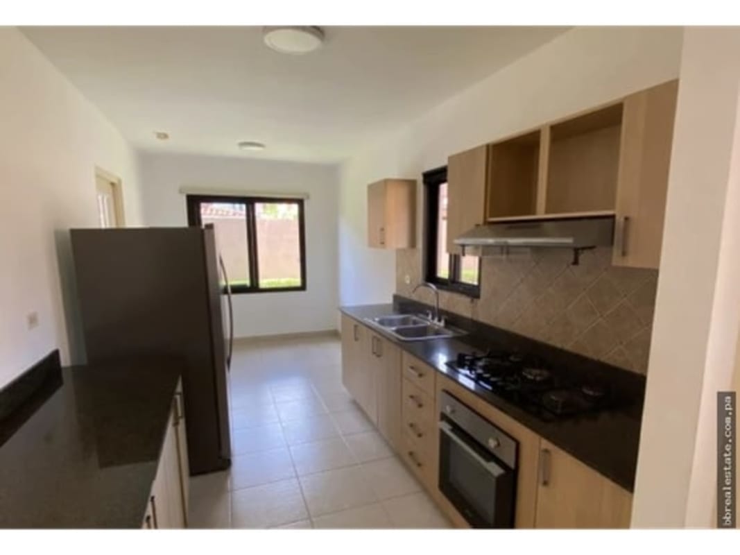 Contemporary kitchen with granite countertops and wood cabinets in Versalles Costa Sur Panama