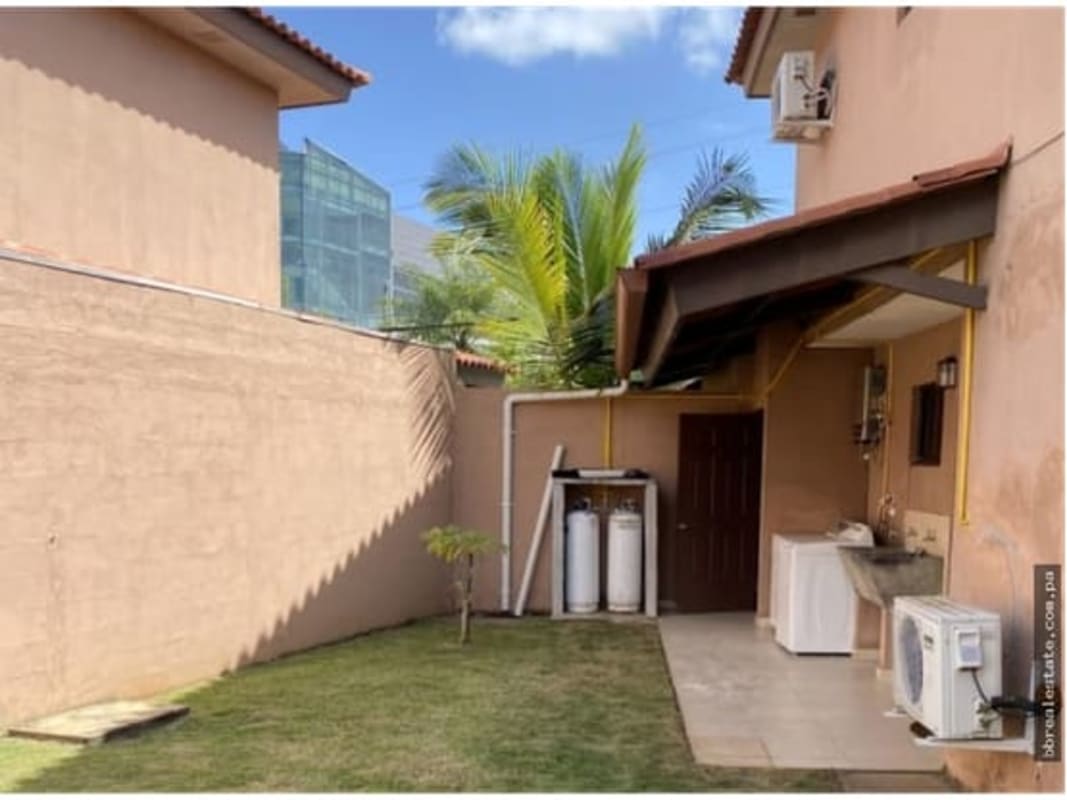 View of fenced garden and covered terrace at Versalles Costa Sur residence Panama