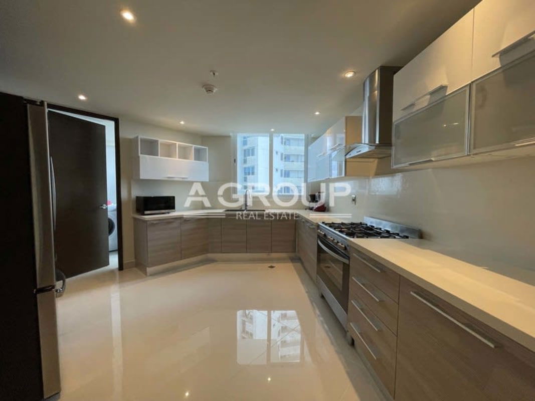 Contemporary kitchen with quartz countertops and built-in appliances at The Regent Costa del Este Panama
