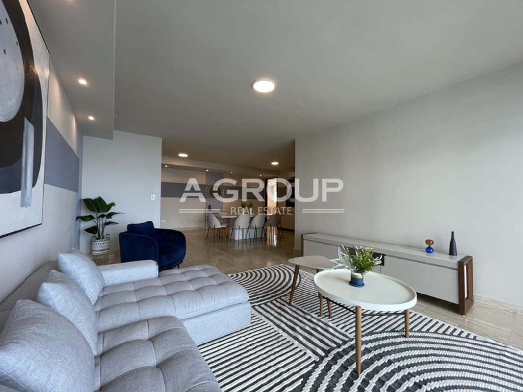 Modern dining room with eight-seat table, wall art in The Regent Costa del Este Panama