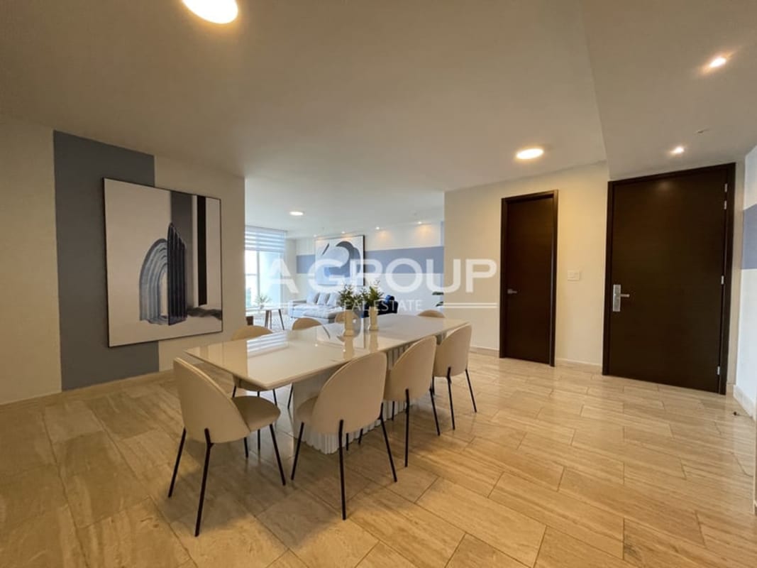 Living room with striped accent wall, gray sofa, TV console in The Regent Costa del Este