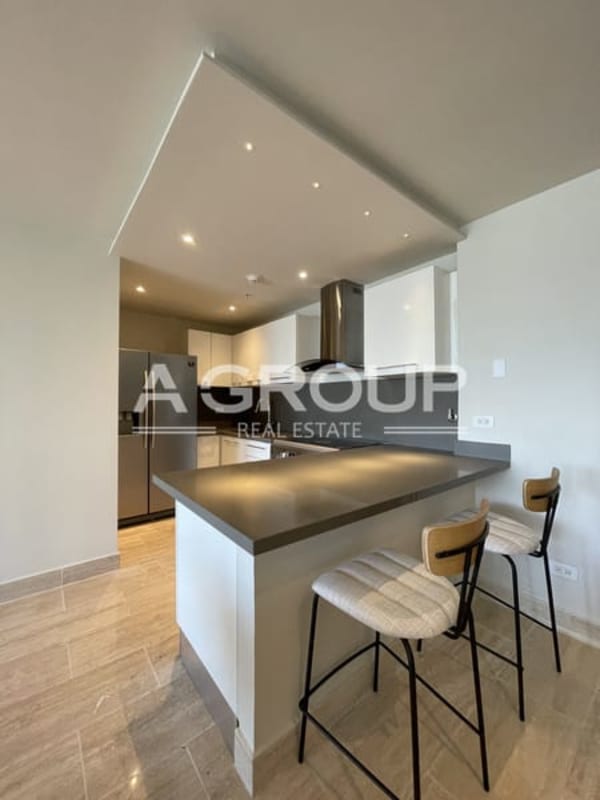 Modern kitchen with granite countertops and built-in appliances in The Regent Panama City