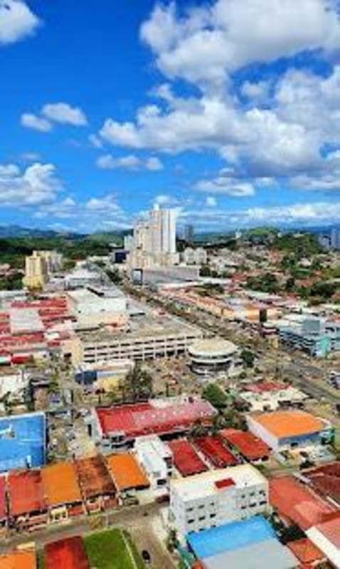 City skyline aerial over Dos Mares neighborhood showing residential towers and main roads in Panama City